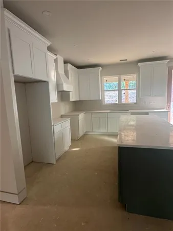 a kitchen with stainless steel appliances a refrigerator a sink dishwasher and cabinets with wooden floor