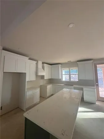 a kitchen with cabinets and window