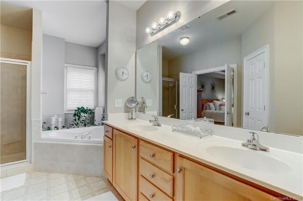 3288 Richard's Crossing Fort Mill, SC 29708 - Photo 21 of 36 a bathroom with a sink double vanity granite tub shower and a mirror