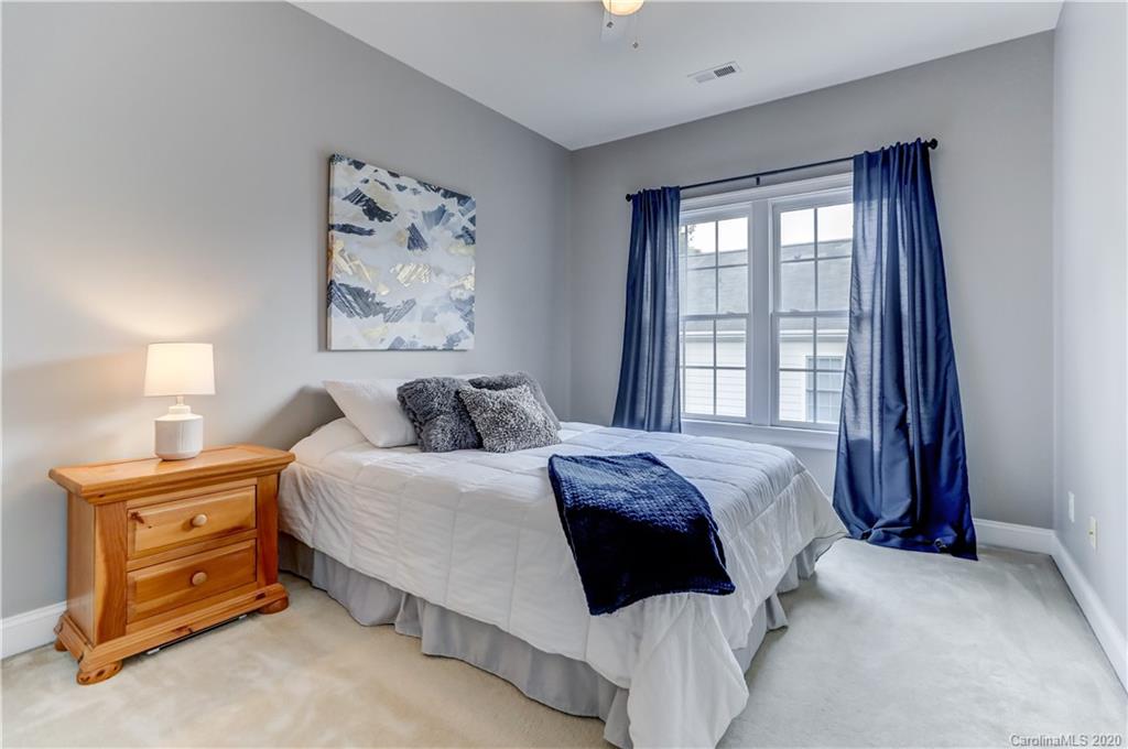 3288 Richard's Crossing Fort Mill, SC 29708 - Photo 24 of 36 a spacious bedroom with a bed a couch and a window