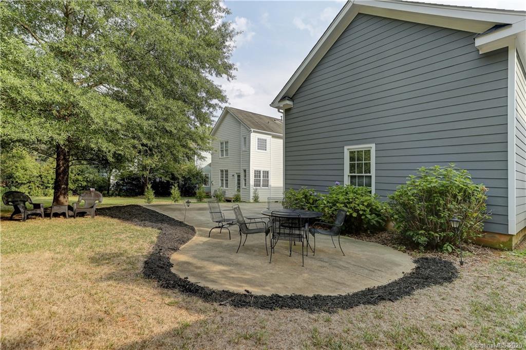 3288 Richard's Crossing Fort Mill, SC 29708 - Photo 32 of 36 a backyard of a house with outdoor seating and trees