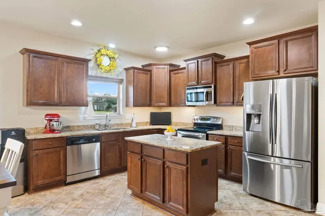 a kitchen with a sink appliances and cabinets