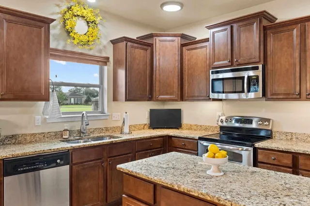 a kitchen with a sink a stove and cabinets