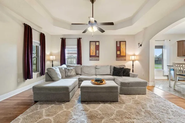 a living room with furniture and a chandelier