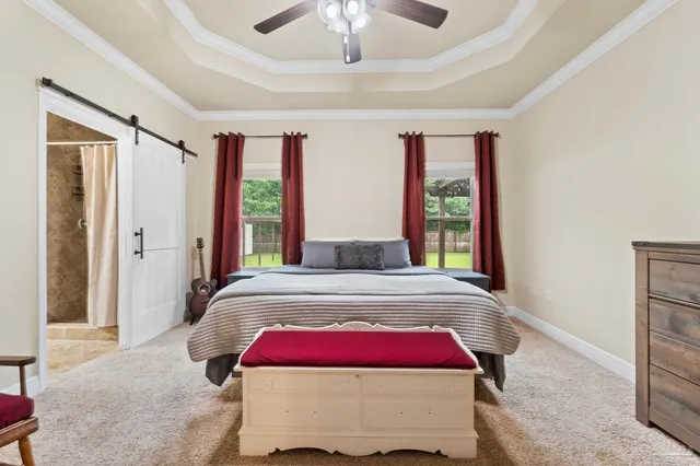 a bedroom with a large bed and a window