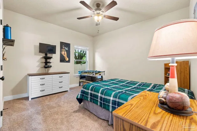 a bedroom with two bed and a window