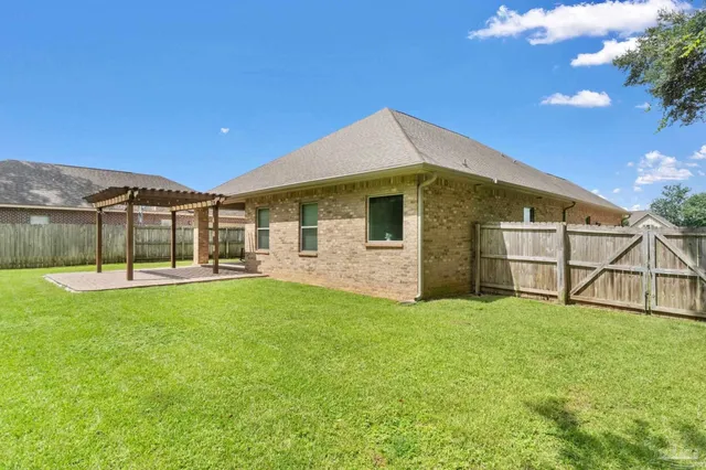 a view of a house with a backyard porch and sitting area