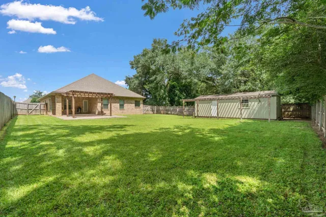 a view of a backyard with a iron fence