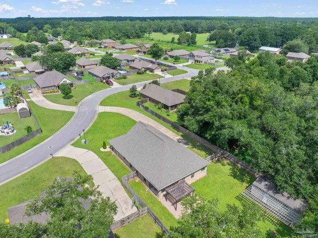 an aerial view of residential houses with outdoor space and street view