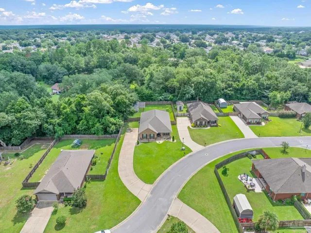 an aerial view of a house with outdoor space and pool