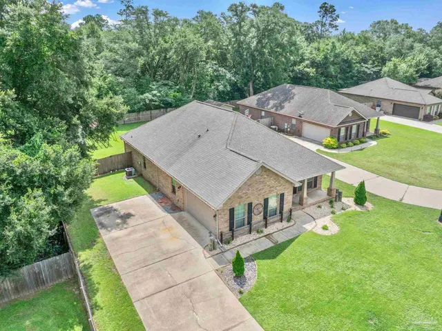 a view of a house with backyard sitting area and garden