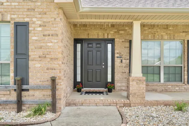 a front view of a house with a garden