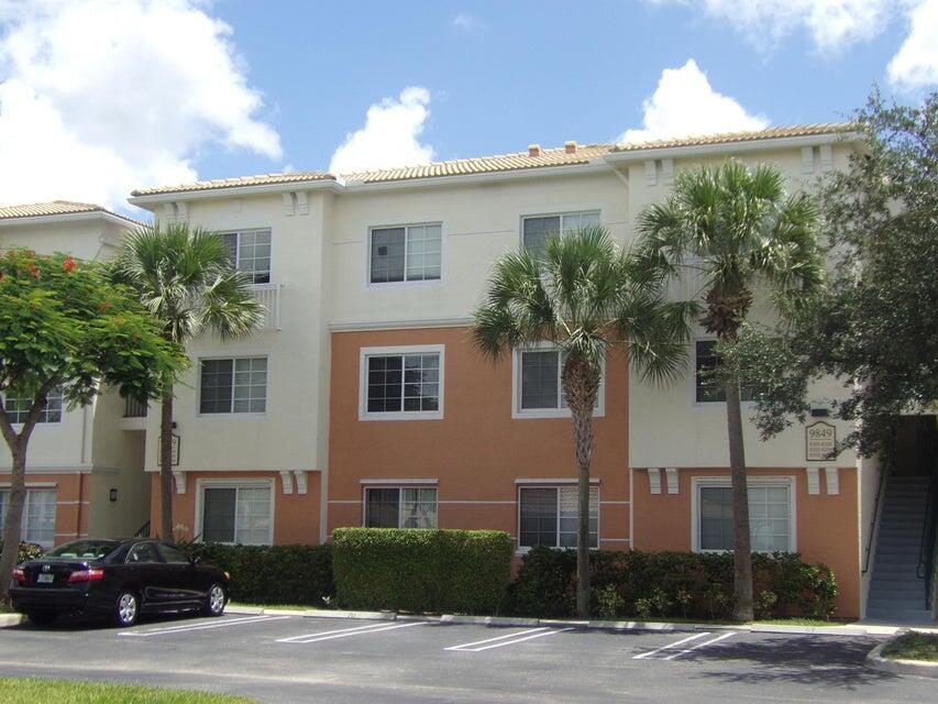 9849 Baywinds Boulevard, Unit 8306 West Palm Beach, FL 33411 - Photo 1 of 24 a front view of a house with a yard and garage