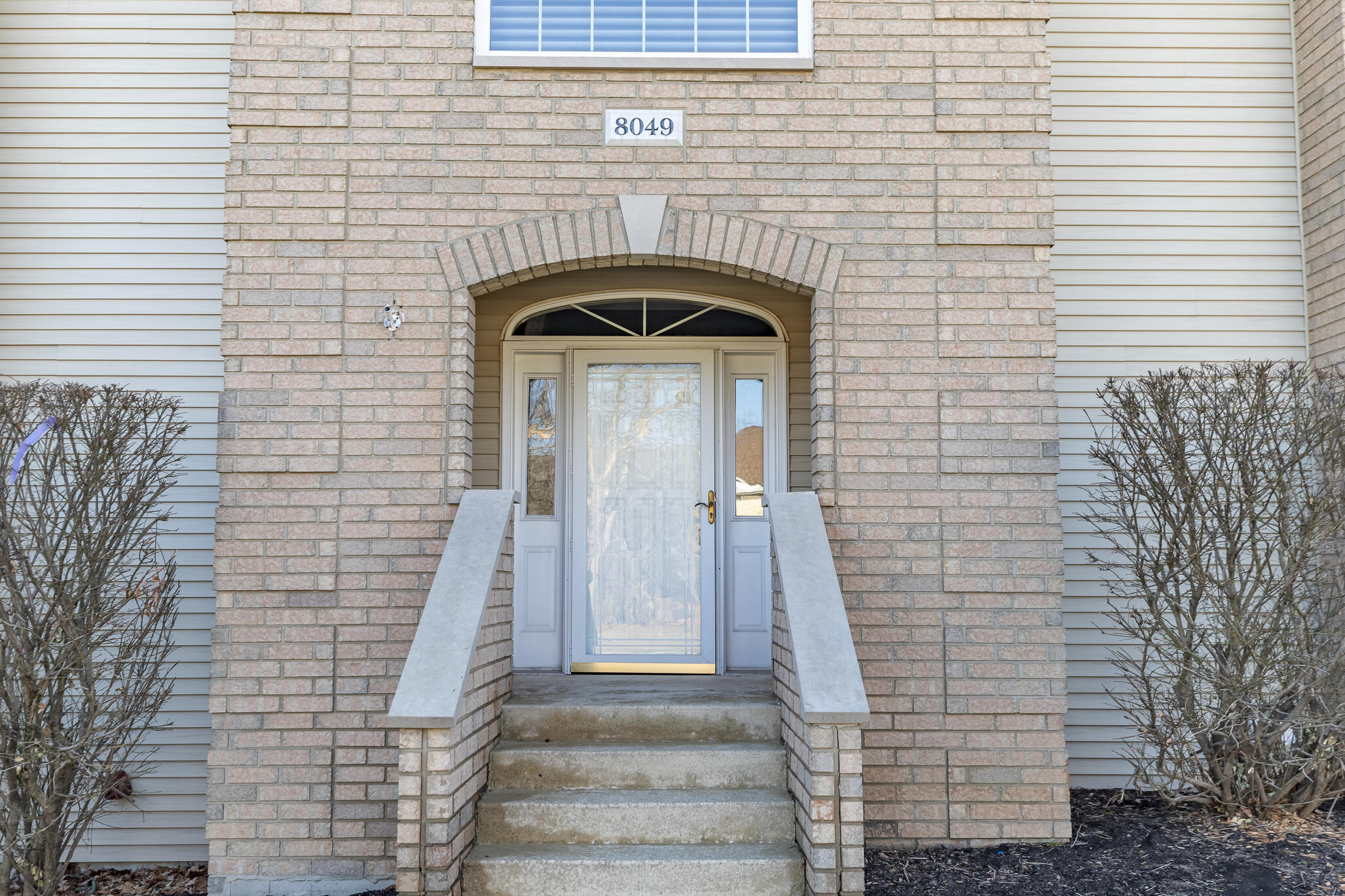 8049 West 85th Court Crown Point, IN 46307 - Photo 16 of 50 a front view of a house with stairs