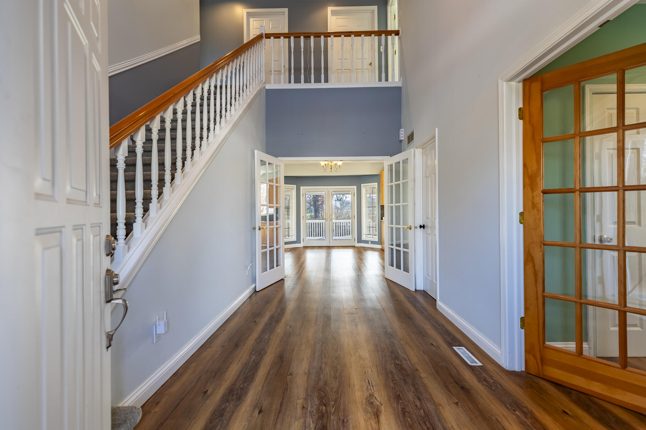 8049 West 85th Court Crown Point, IN 46307 - Photo 17 of 50 a view of a hallway with wooden floor and staircase
