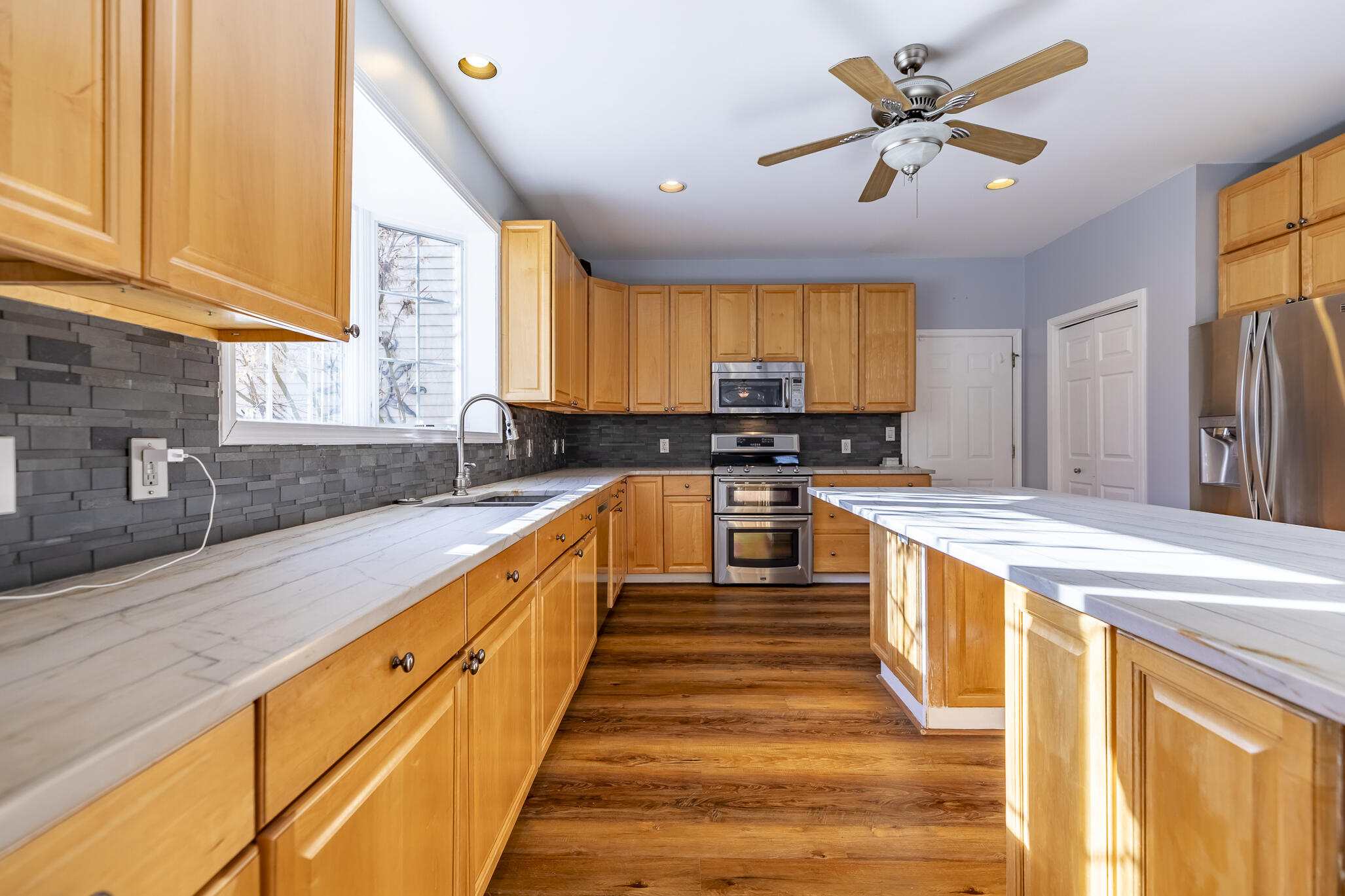 8049 West 85th Court Crown Point, IN 46307 - Photo 22 of 47 a large kitchen with stainless steel appliances granite countertop a sink a stove counter space and cabinets