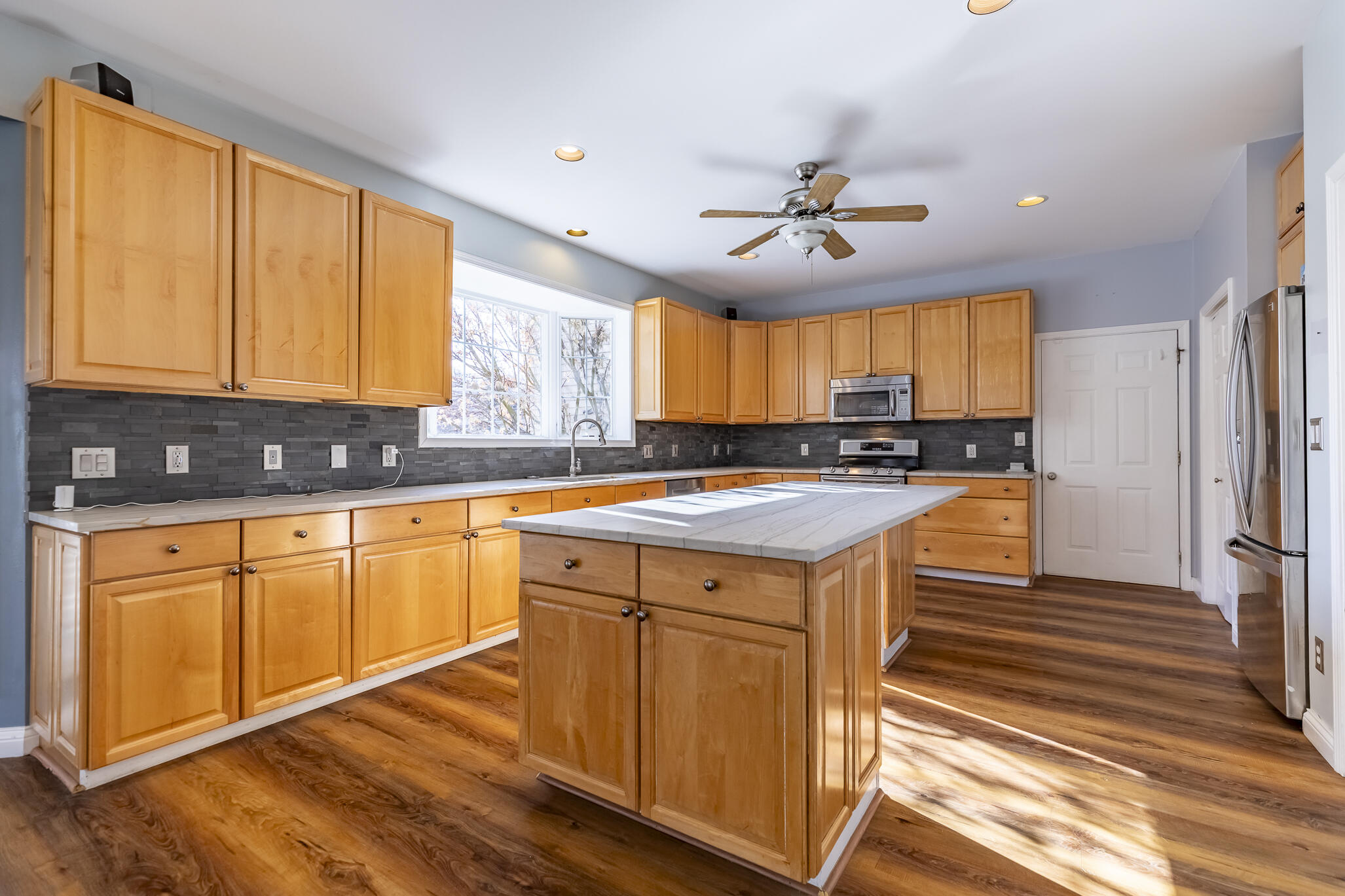 8049 West 85th Court Crown Point, IN 46307 - Photo 22 of 50 a kitchen with stainless steel appliances granite countertop wooden cabinets a sink and dishwasher with wooden floor