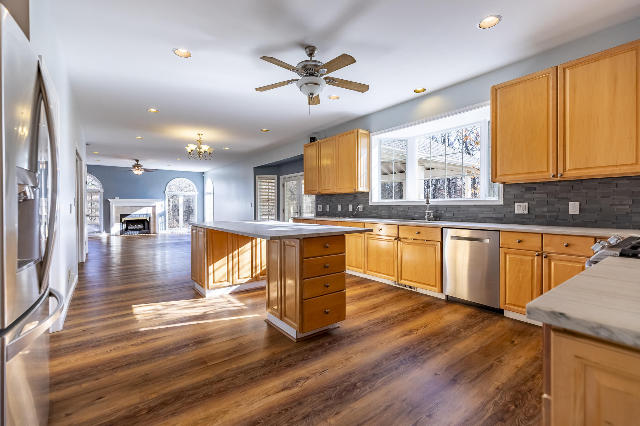 8049 West 85th Court Crown Point, IN 46307 - Photo 23 of 47 a kitchen with stainless steel appliances granite countertop wooden floors and view living room
