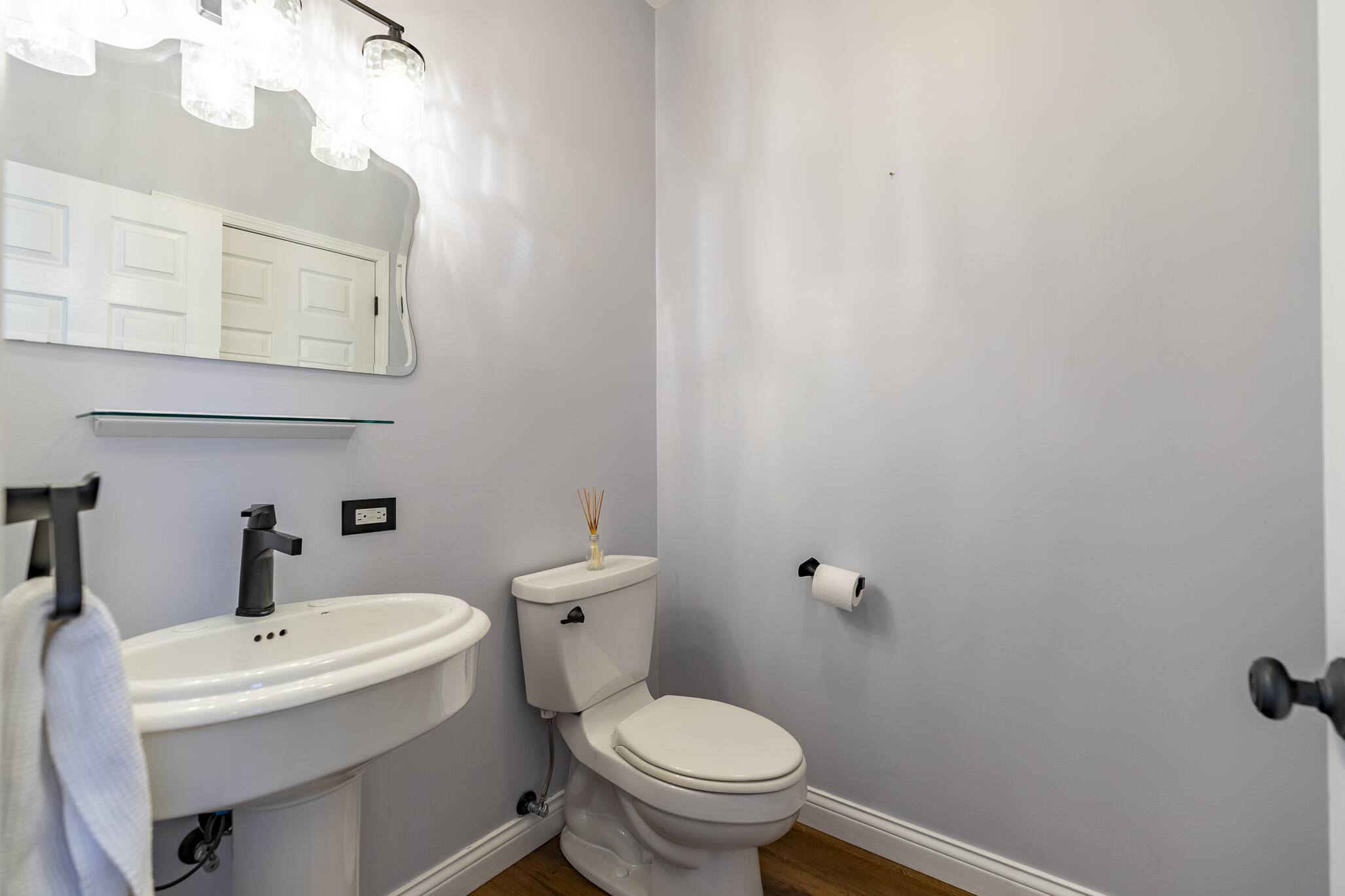 8049 West 85th Court Crown Point, IN 46307 - Photo 26 of 47 a white toilet sitting next to a bathroom sink