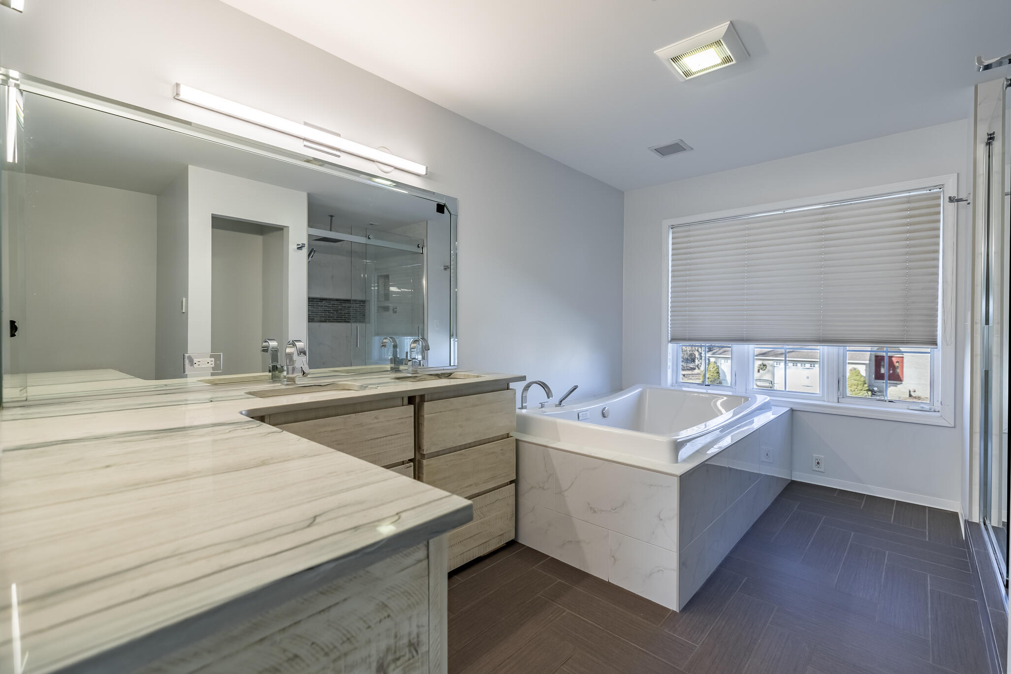 8049 West 85th Court Crown Point, IN 46307 - Photo 29 of 47 a bathroom with a sink a large mirror and a bathtub