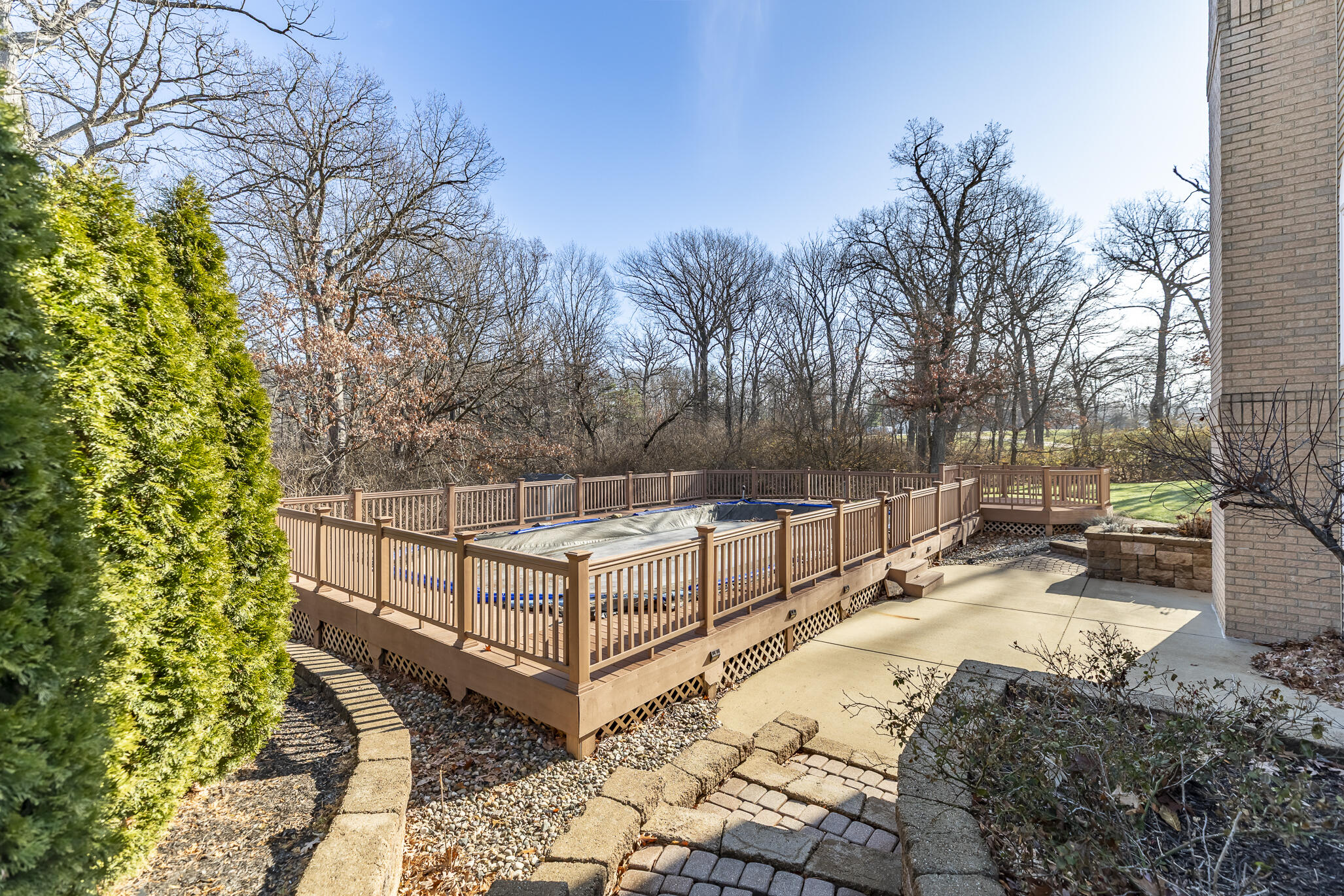 8049 West 85th Court Crown Point, IN 46307 - Photo 9 of 47 a view of a backyard with large trees and wooden fence