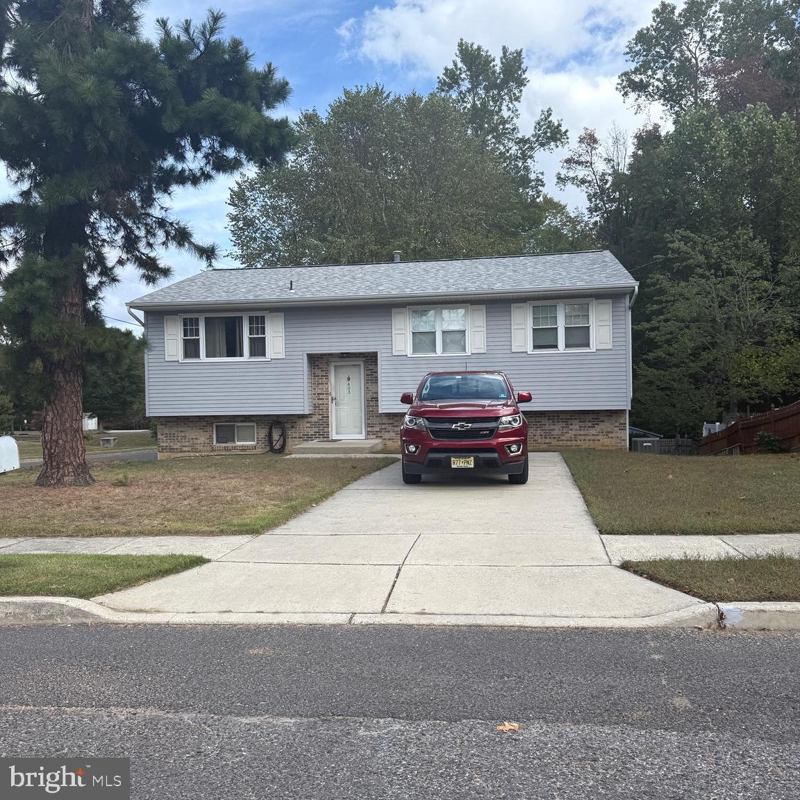 403 Roosevelt Avenue Clementon, NJ 08021 - Photo 24 of 26 a car parked in front of a white house
