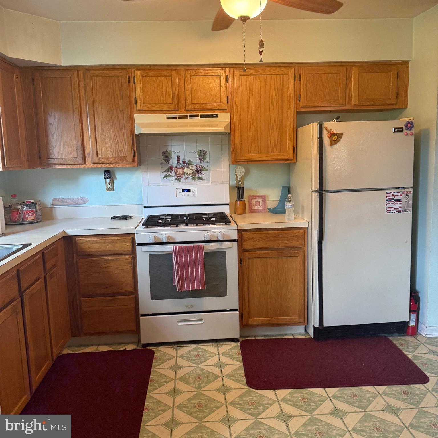 403 Roosevelt Avenue Clementon, NJ 08021 - Photo 6 of 26 a kitchen with a white cabinets and white appliances