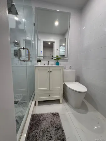 a bathroom with a sink a mirror and shower