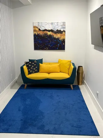 a blue bed sitting in a room next to a blue couch