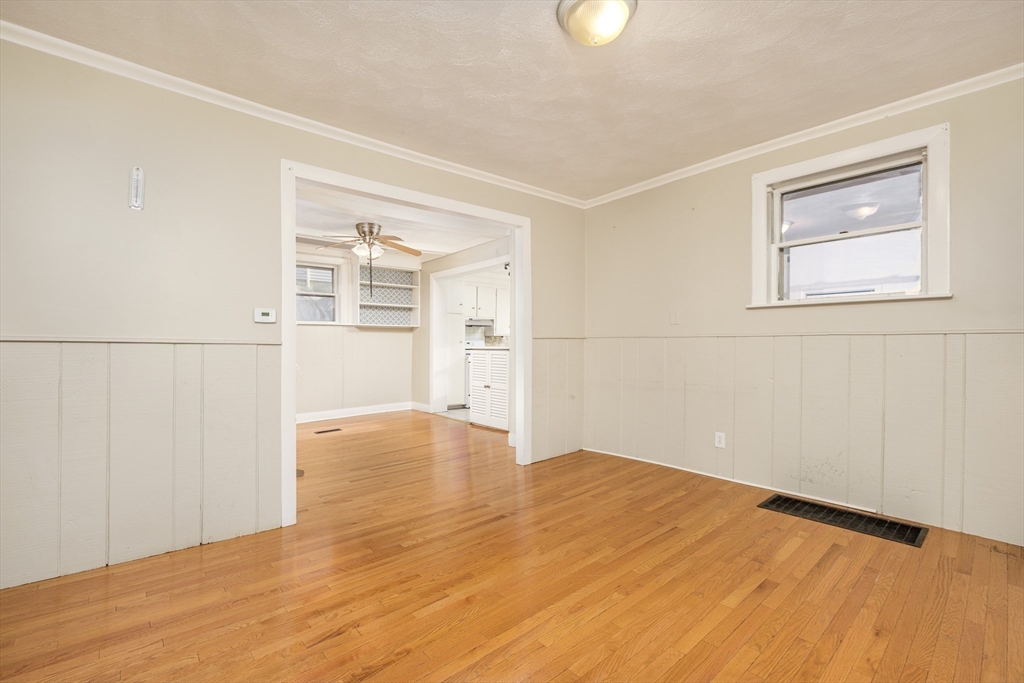 20 Hatch Street Everett, MA 02149 - Photo 5 of 16 a view of empty room with wooden floor and fan