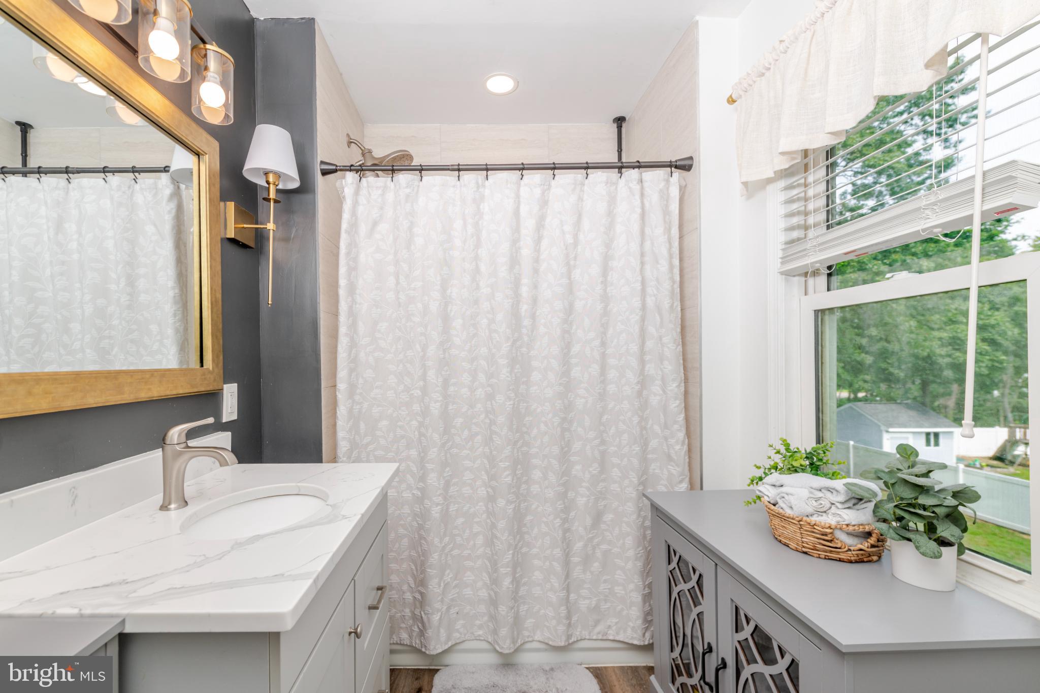 16 Townsend Avenue Berlin, NJ 08009 - Photo 28 of 50 a bathroom with a granite countertop sink and a mirror