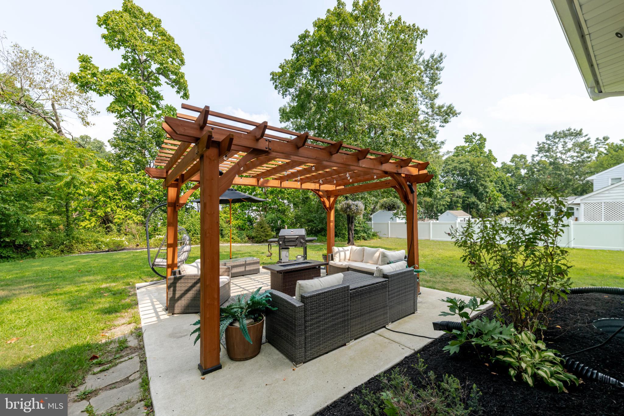 16 Townsend Avenue Berlin, NJ 08009 - Photo 35 of 50 a view of a patio with couches table and chairs and potted plants