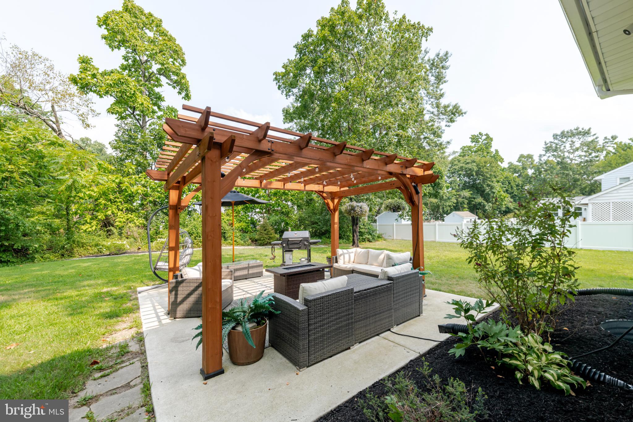 16 Townsend Avenue Berlin, NJ 08009 - Photo 39 of 50 a view of a patio with couches table and chairs and potted plants