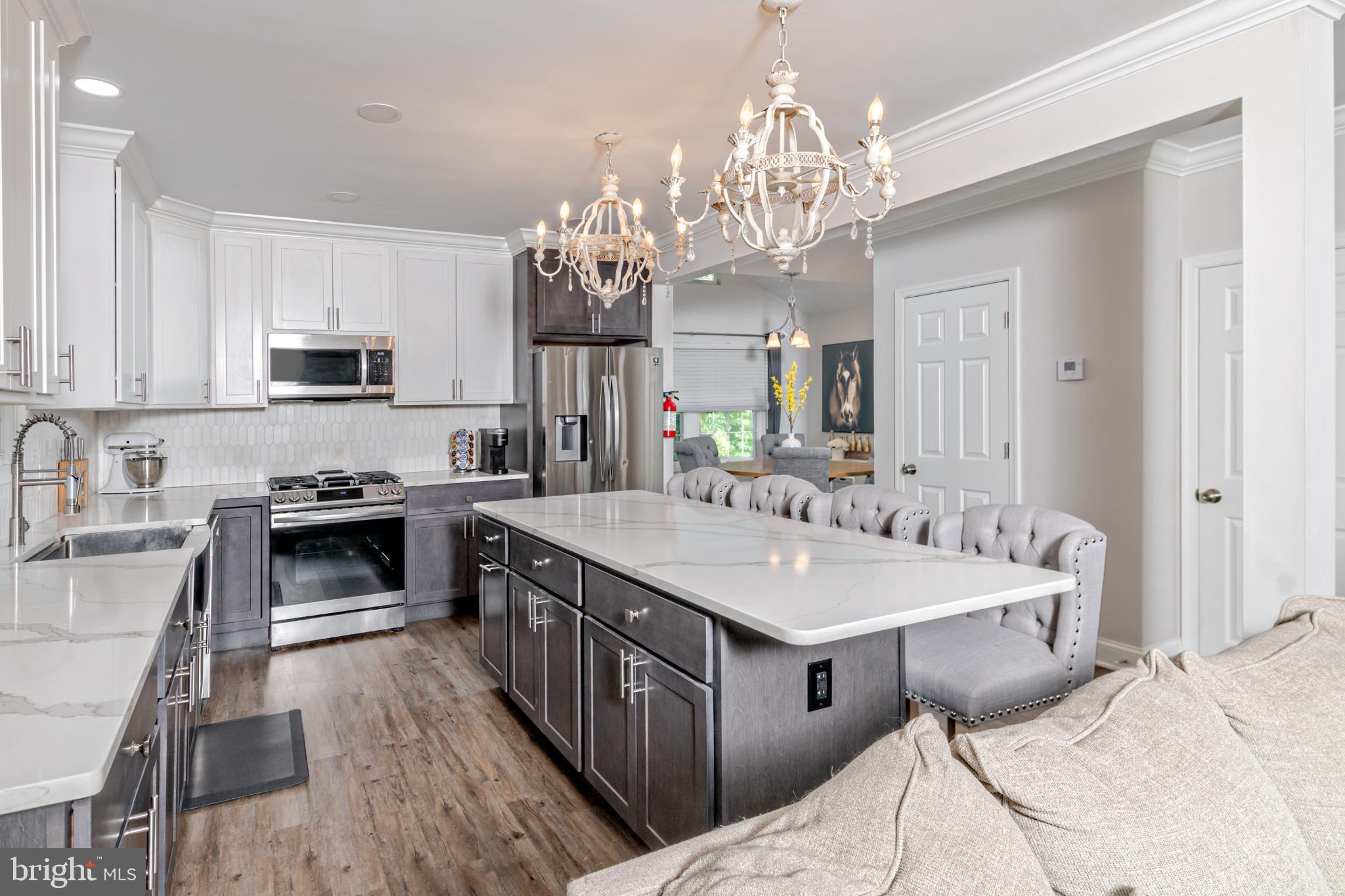 16 Townsend Avenue Berlin, NJ 08009 - Photo 9 of 50 a kitchen with stainless steel appliances granite countertop a stove top oven a sink dishwasher and a dining table with wooden floor