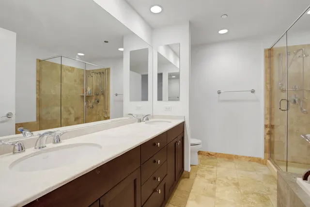 a bathroom with a double vanity sink mirror and shower