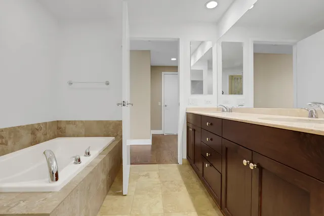 a bathroom with a bathtub sink and mirror
