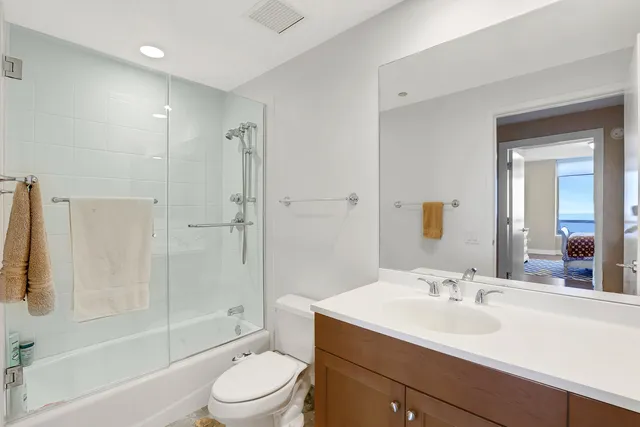 a bathroom with a sink toilet tub and shower