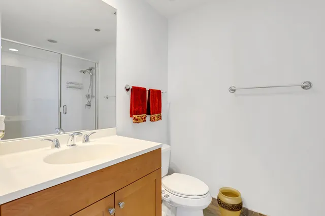 a bathroom with a sink toilet and a mirror