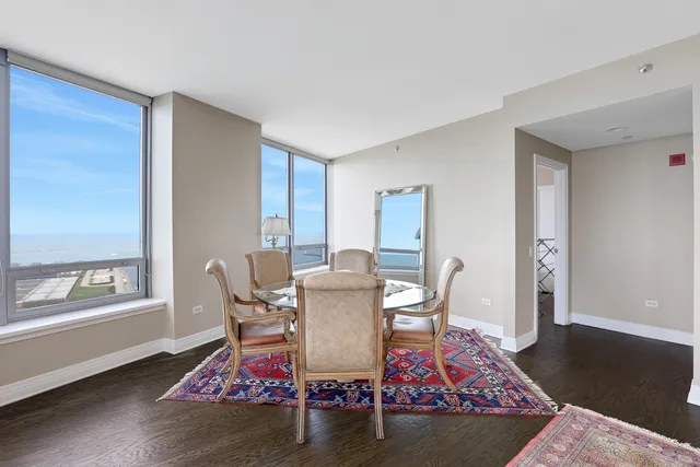 a dining room with wooden floor and a table