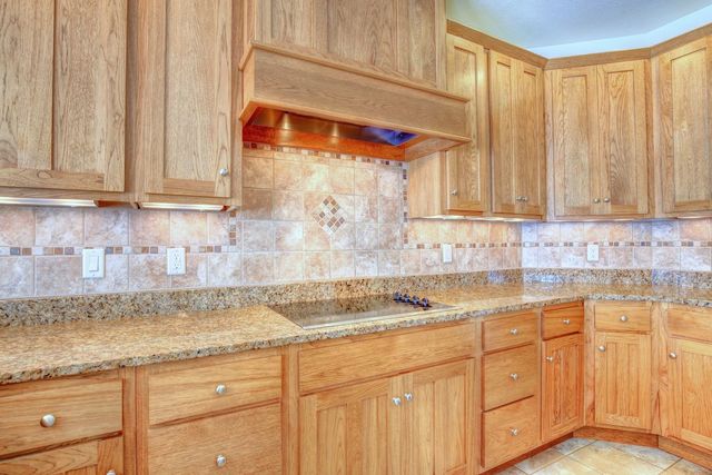 8038 Adam Road Weldon, IL 61882 - Photo 17 of 53 a kitchen with stainless steel appliances granite countertop a sink and cabinets with wooden floor