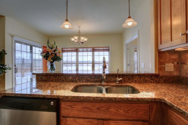 8038 Adam Road Weldon, IL 61882 - Photo 19 of 53 a view of a kitchen with granite countertop a sink and a window