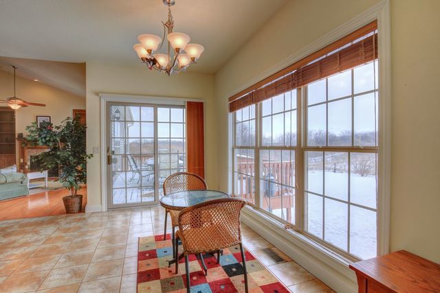 8038 Adam Road Weldon, IL 61882 - Photo 21 of 53 a living room filled with furniture and a floor to ceiling window