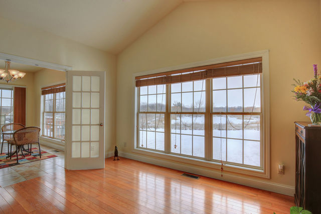 8038 Adam Road Weldon, IL 61882 - Photo 24 of 53 a view of an empty room with wooden floor and a window