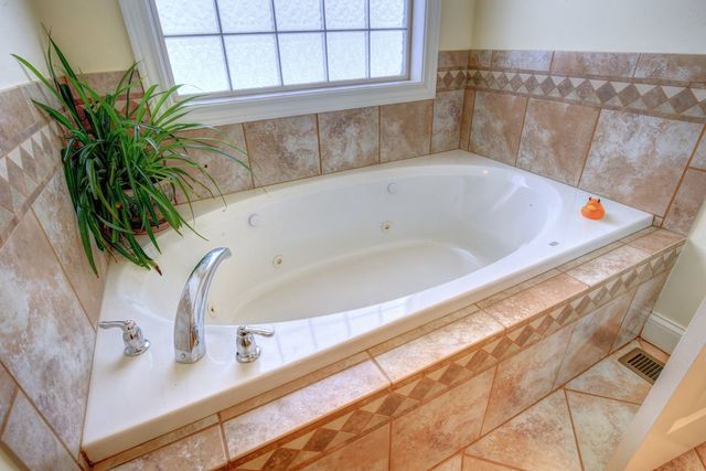 8038 Adam Road Weldon, IL 61882 - Photo 28 of 53 a bathroom with a bathtub and sink