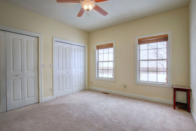 8038 Adam Road Weldon, IL 61882 - Photo 29 of 53 an empty room with chandelier fan and windows