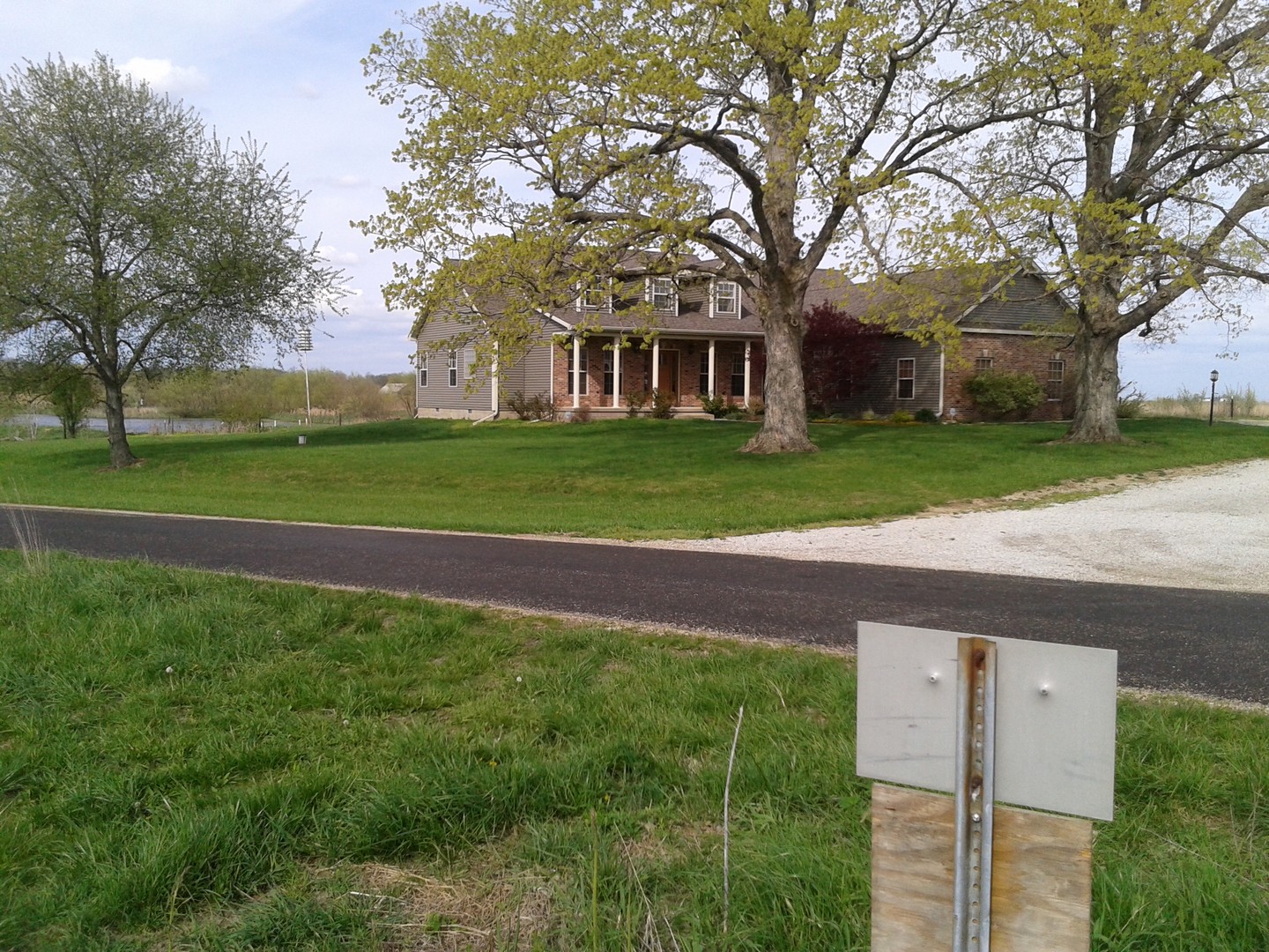 8038 Adam Road Weldon, IL 61882 - Photo 41 of 53 a view of a house next to a big yard and large trees