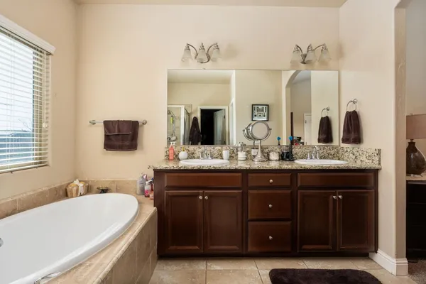 a view of a house with swimming pool and sitting area