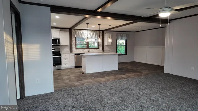 a view of a kitchen with a sink and refrigerator
