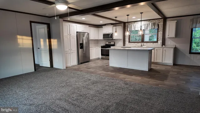 a view of a kitchen with a refrigerator and microwave
