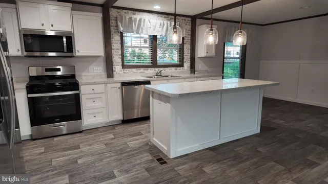 a view of a kitchen with refrigerator and a stove